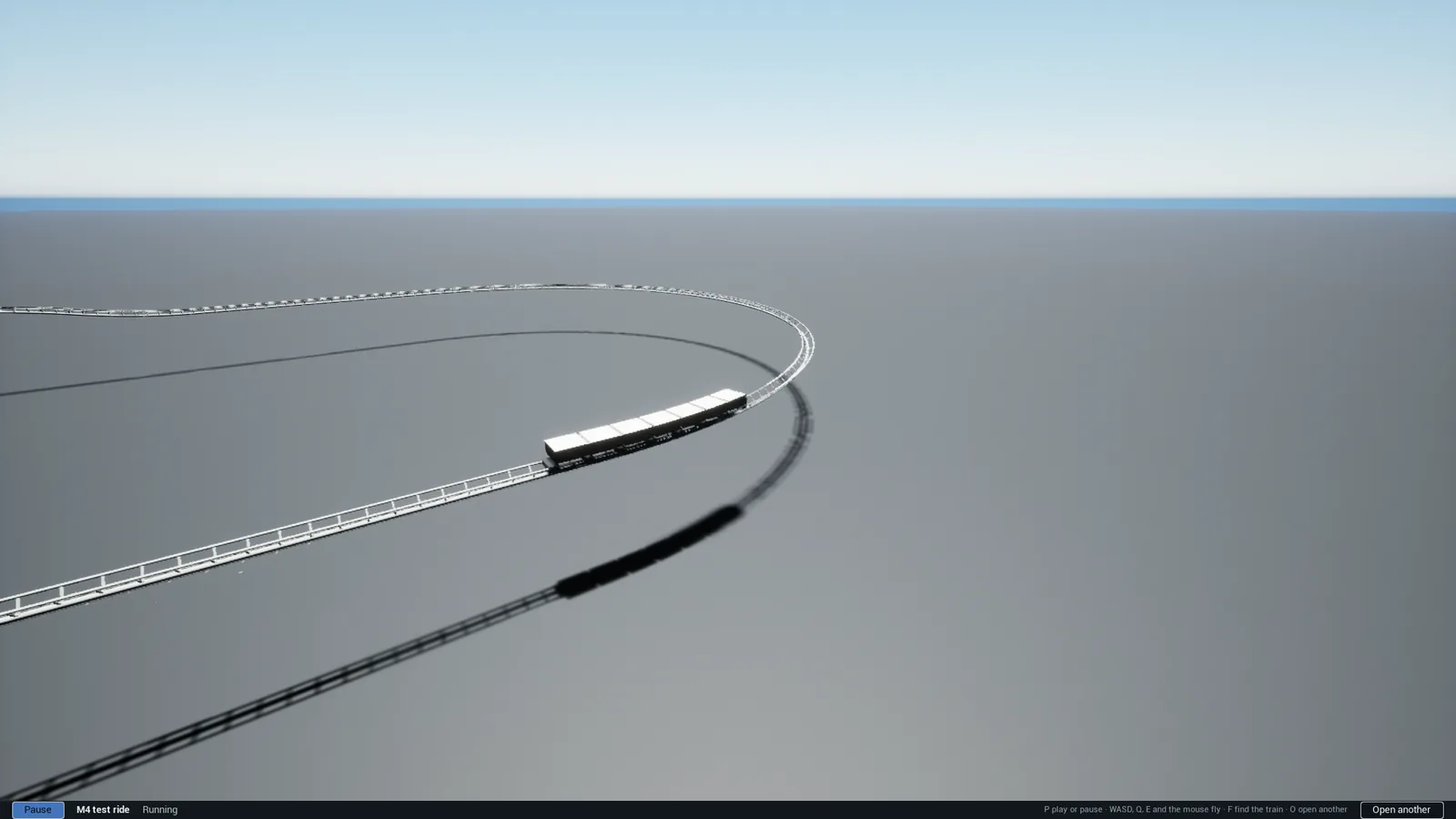 A grey test track curving across a flat grey plane under a blue sky, with a plain white test train on it.